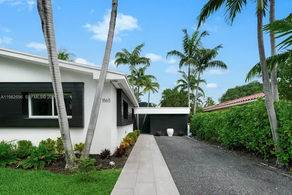 a front view of a house with a yard and a garage