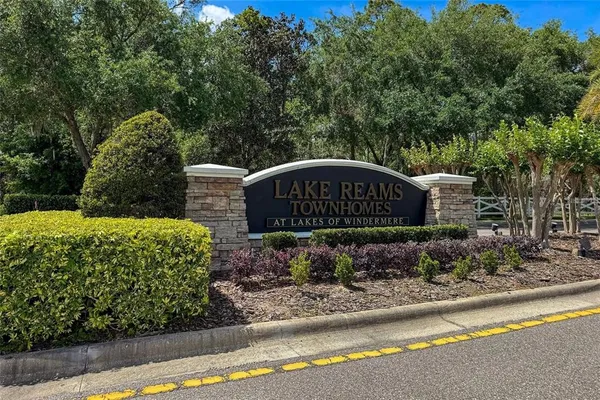 a wooden bench sitting in front of a garden