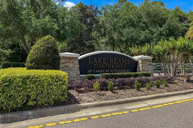 a wooden bench sitting in front of a garden
