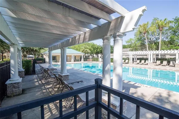 a view of a porch with chairs and backyard