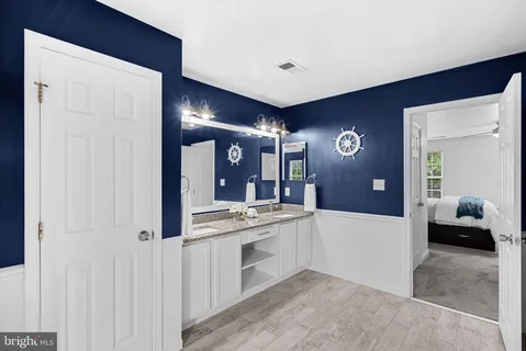 a large bathroom with a double vanity sink and a mirror