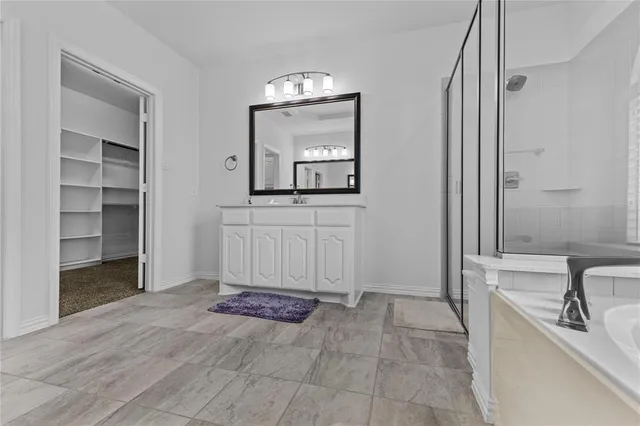 a spacious bedroom with a bed and window