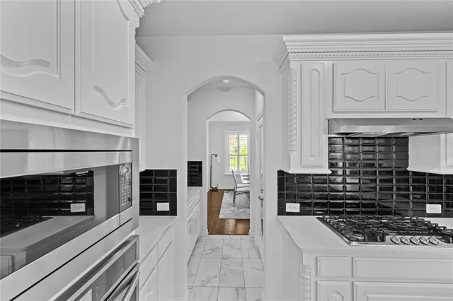 a kitchen with stainless steel appliances granite countertop a stove and a refrigerator