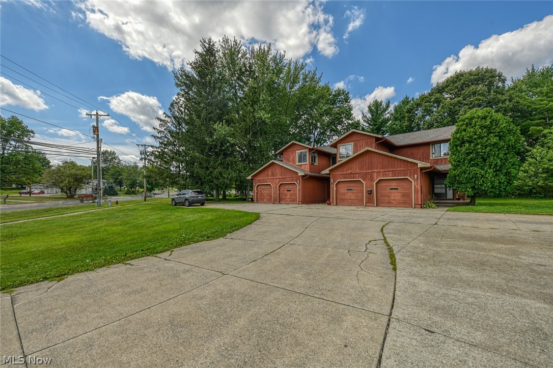 2715 Graham Road, Unit 4 Stow, OH 44224 - Photo 10 of 35 2715 Graham Rd #4, Stow, OH 44224 is an end unit condominium with 2 bedrooms, 1.5 bathrooms, 1 car garage, finished basement, laundry in lower level, huge side yard with pet fence & 3 collars provided, open floor plan from galley kitchen with oak cabinets & appliances to the large living room with wood burning fireplace, sliding glass doors to rear deck and sitting porch up front.
