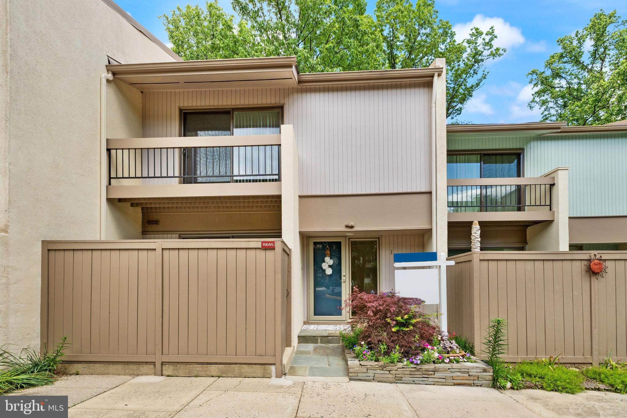 11645 Newbridge Court Reston, VA 20191 - Photo 2 of 62 a front view of a house with a yard