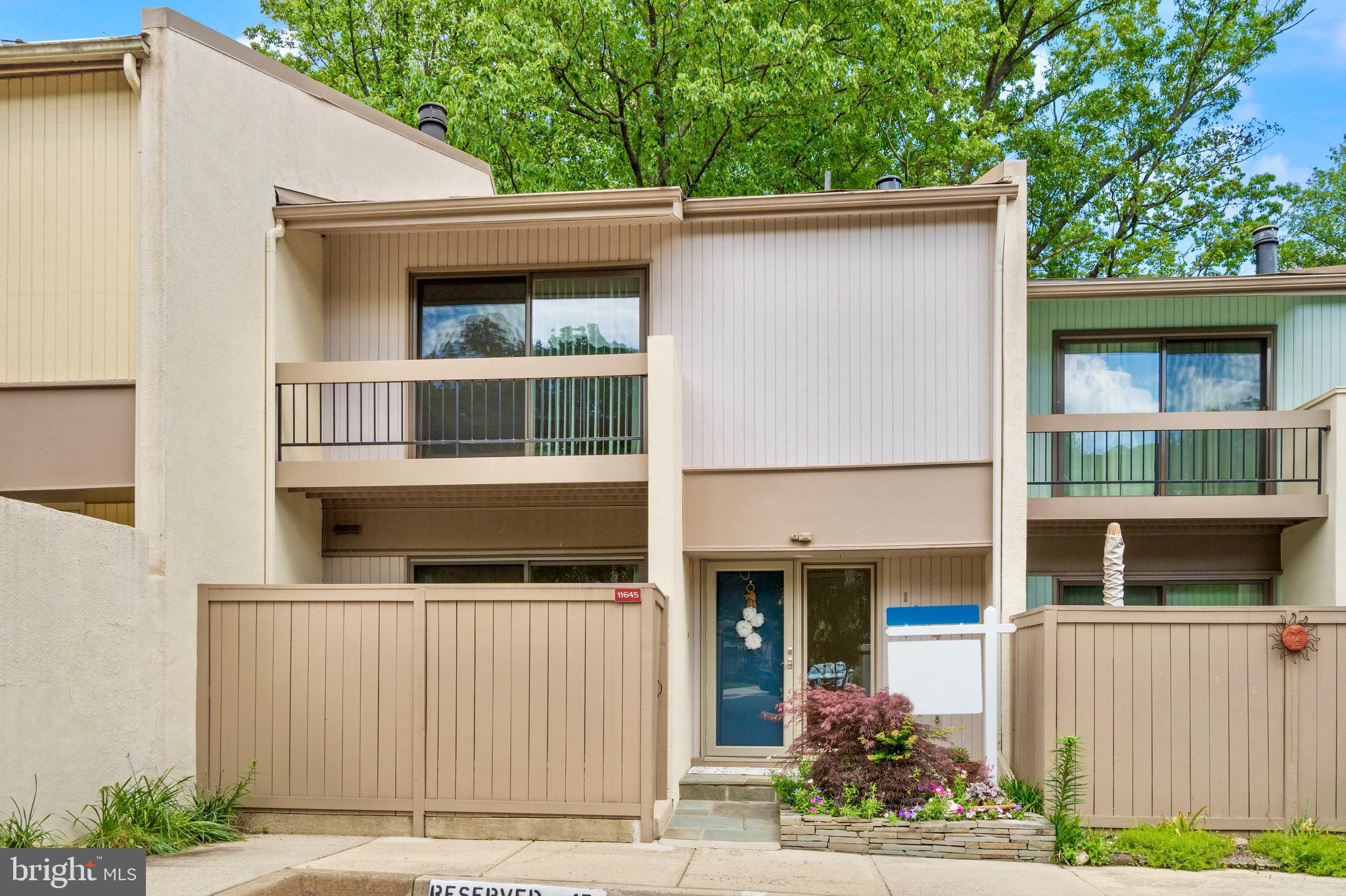 11645 Newbridge Court Reston, VA 20191 - Photo 3 of 62 a front view of a house with a yard