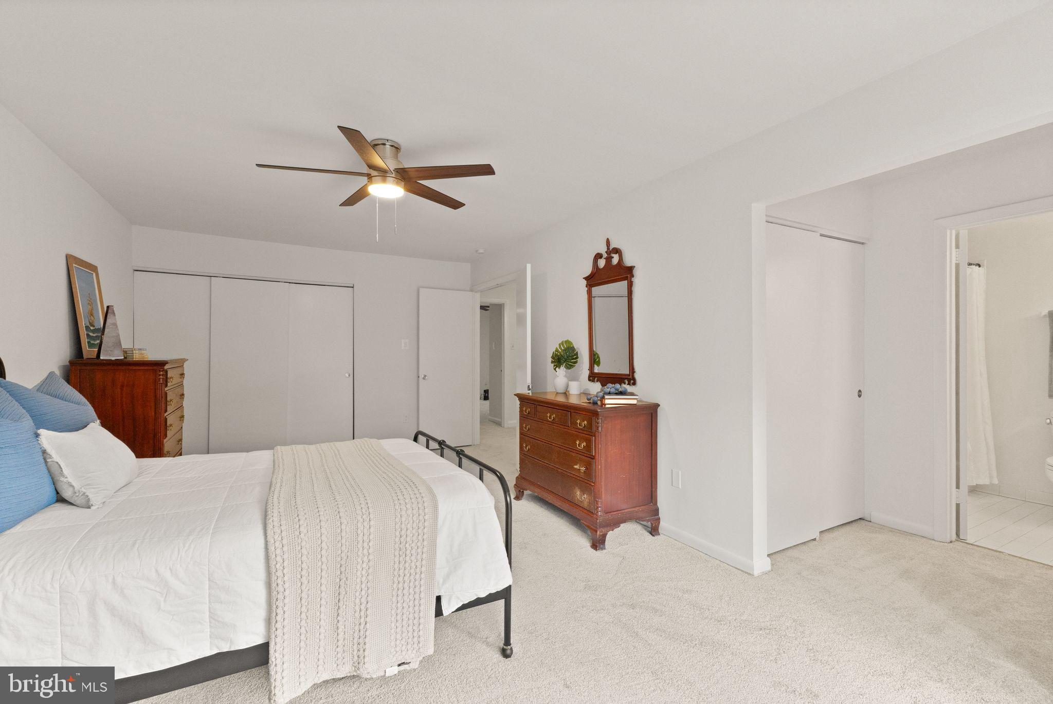 11645 Newbridge Court Reston, VA 20191 - Photo 37 of 62 a bedroom with a bed and a chandelier