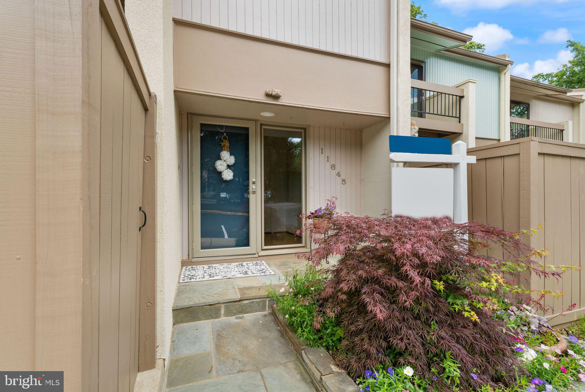 11645 Newbridge Court Reston, VA 20191 - Photo 4 of 62 a front view of a house with a yard