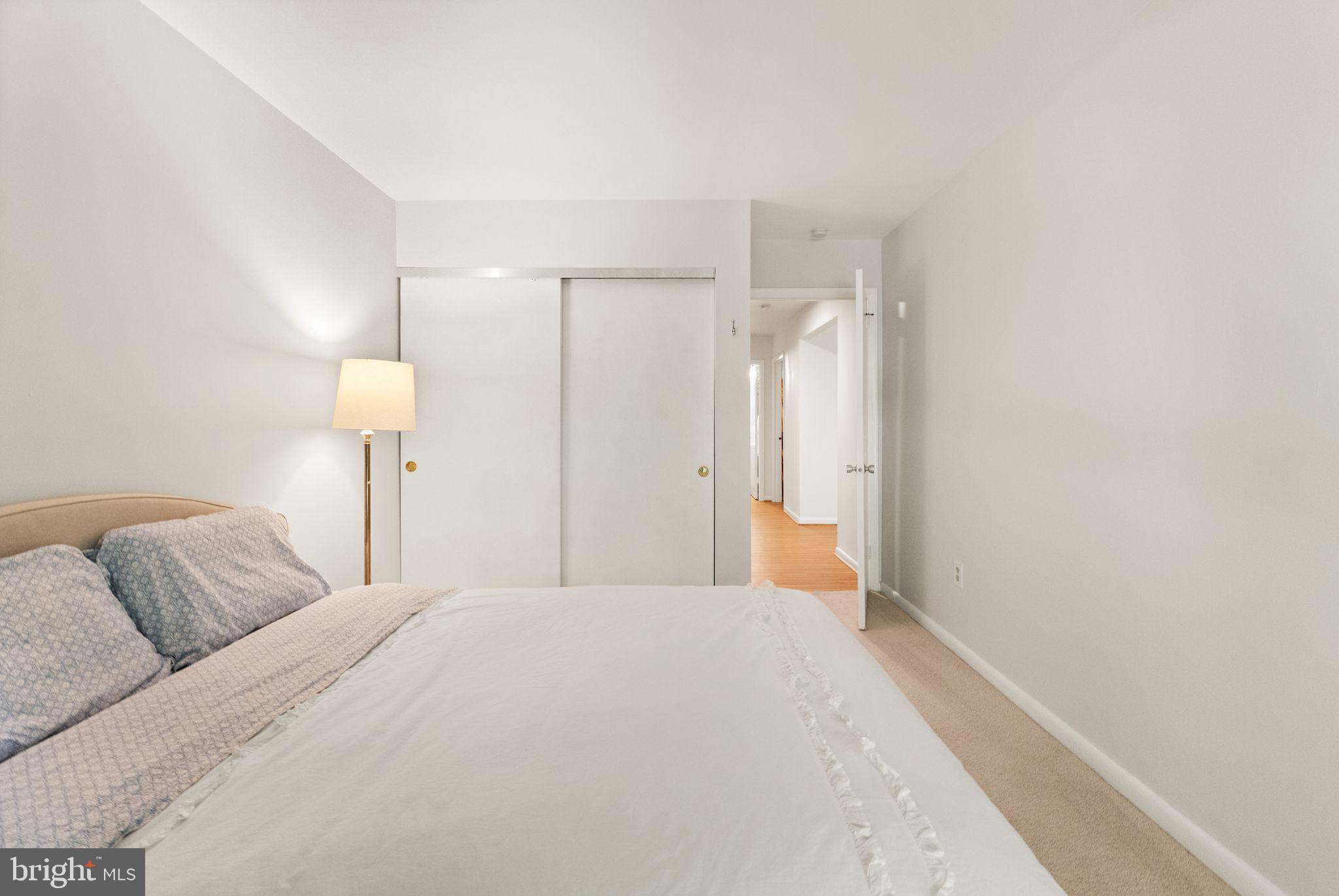11645 Newbridge Court Reston, VA 20191 - Photo 46 of 62 a bedroom with a bed and a lamp