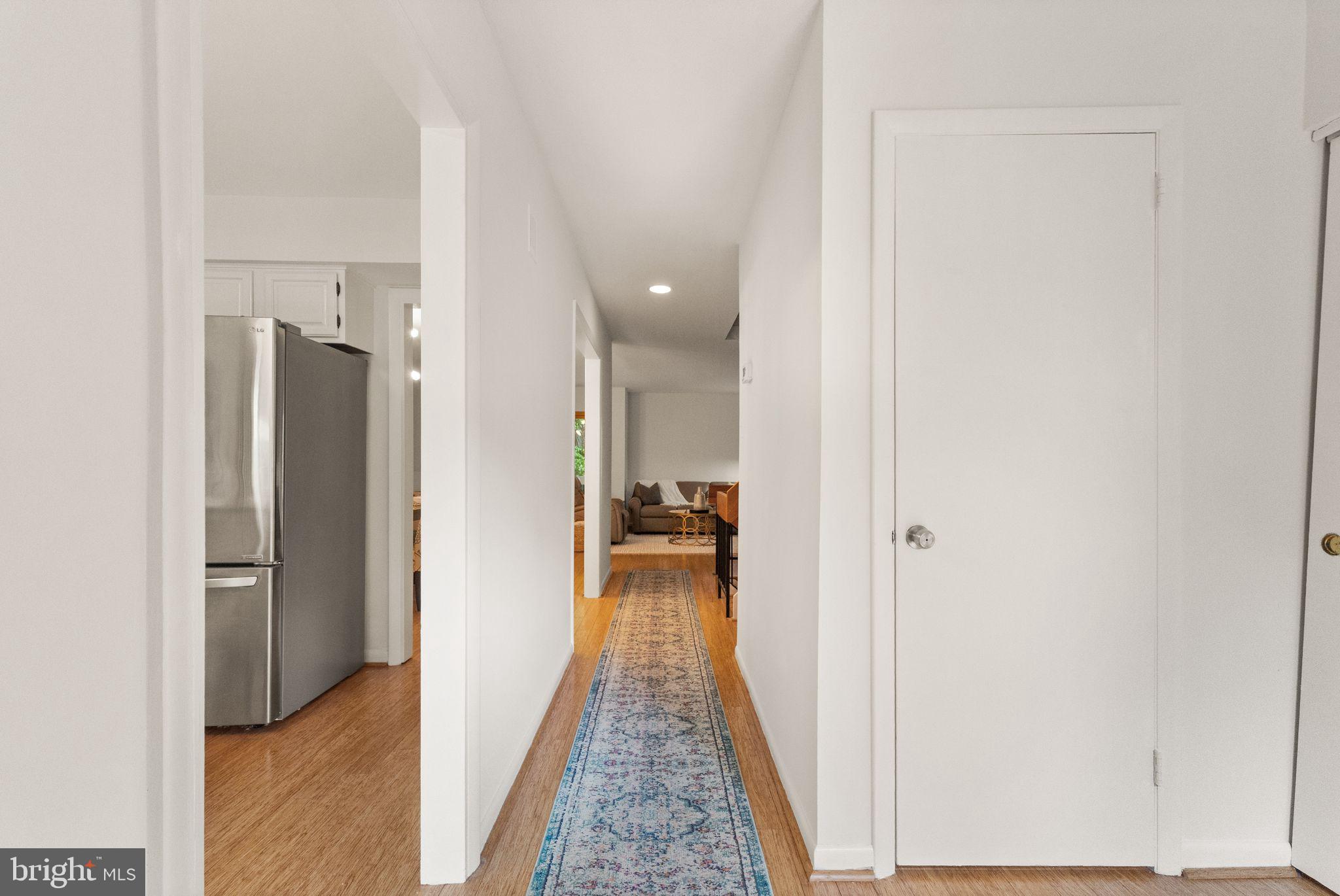 11645 Newbridge Court Reston, VA 20191 - Photo 5 of 62 a view of a hallway with wooden floor and a bathroom