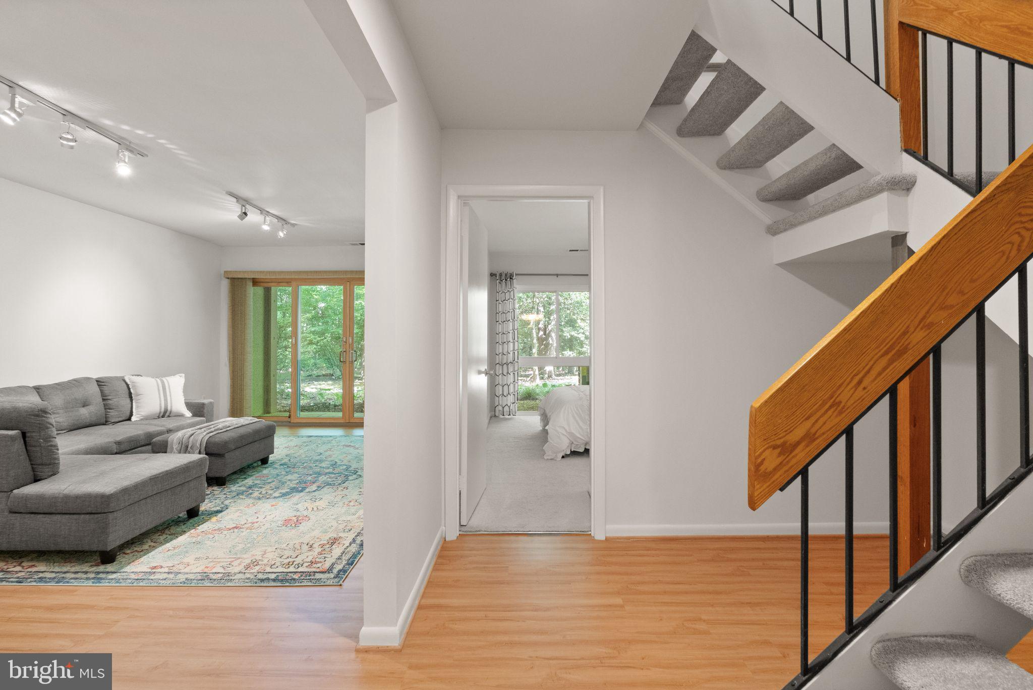11645 Newbridge Court Reston, VA 20191 - Photo 54 of 62 a living room with furniture and stairs