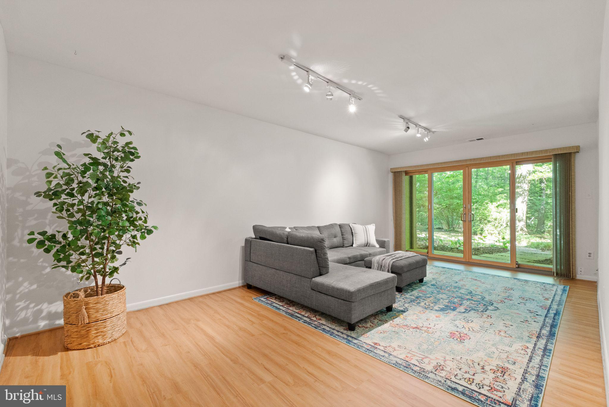 11645 Newbridge Court Reston, VA 20191 - Photo 55 of 62 a living room with furniture and a potted plant