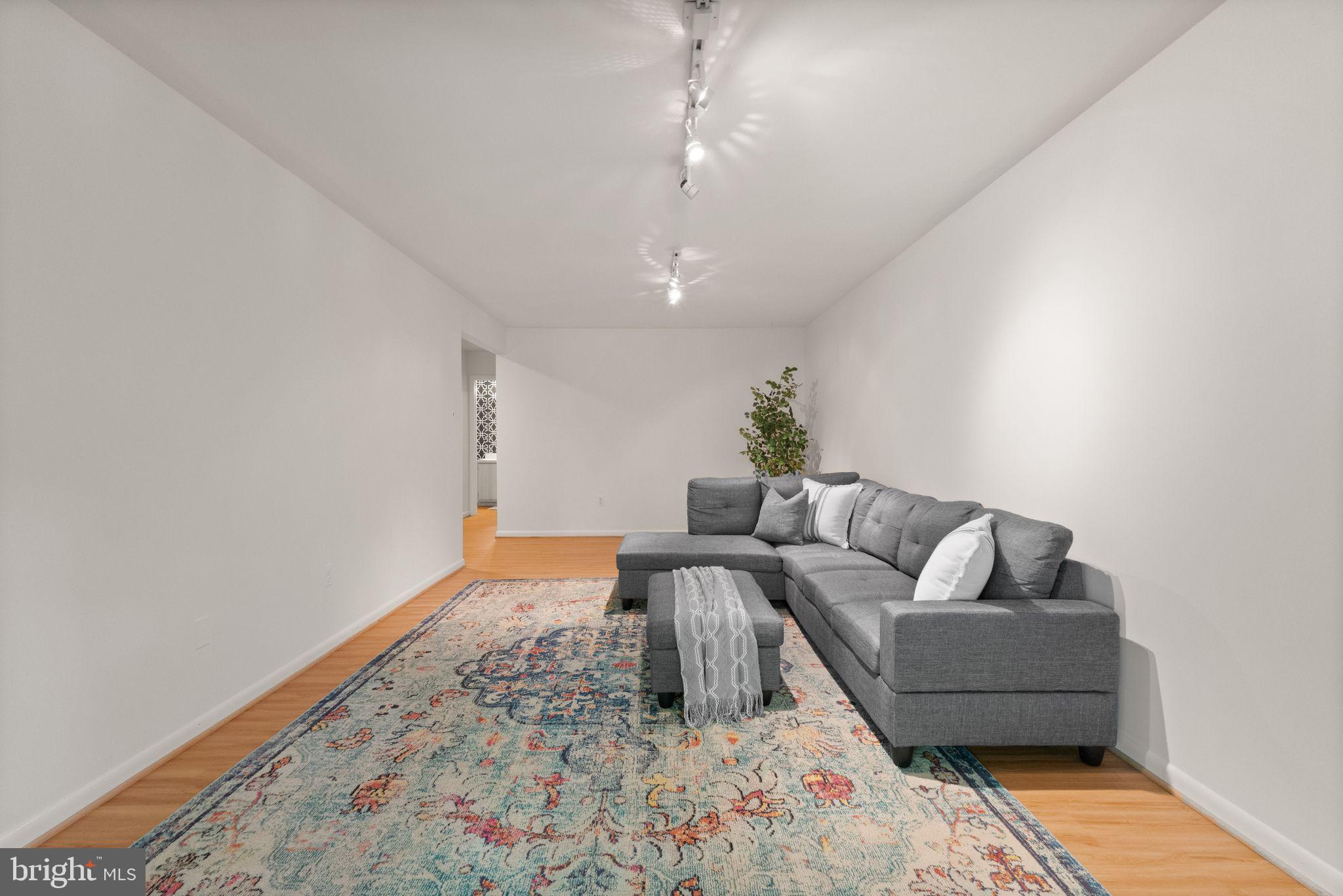 11645 Newbridge Court Reston, VA 20191 - Photo 56 of 62 a living room with furniture and a rug