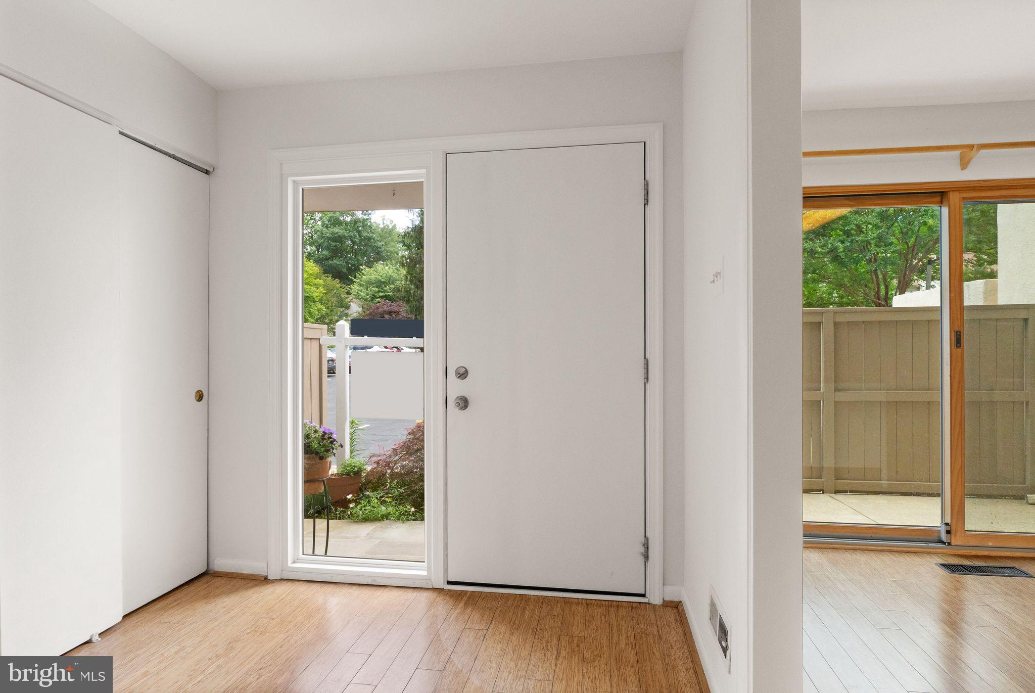 11645 Newbridge Court Reston, VA 20191 - Photo 6 of 62 an empty room with wooden floor view and windows