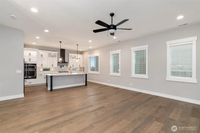 a living room with stainless steel appliances kitchen island furniture and a window