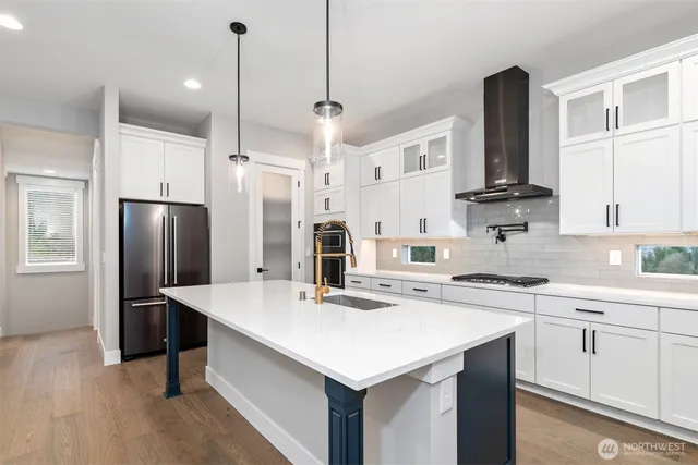 a kitchen with a sink stainless steel appliances and white cabinets