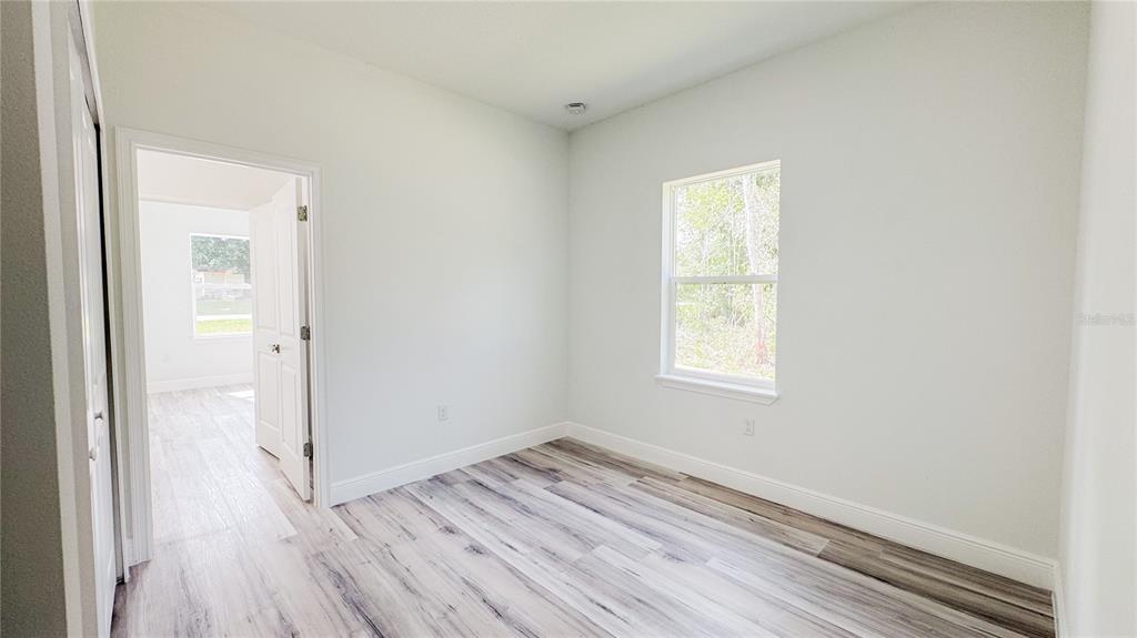 15625 Southwest 37th Circle Ocala, FL 34473 - Photo 18 of 27 an empty room with wooden floor and windows