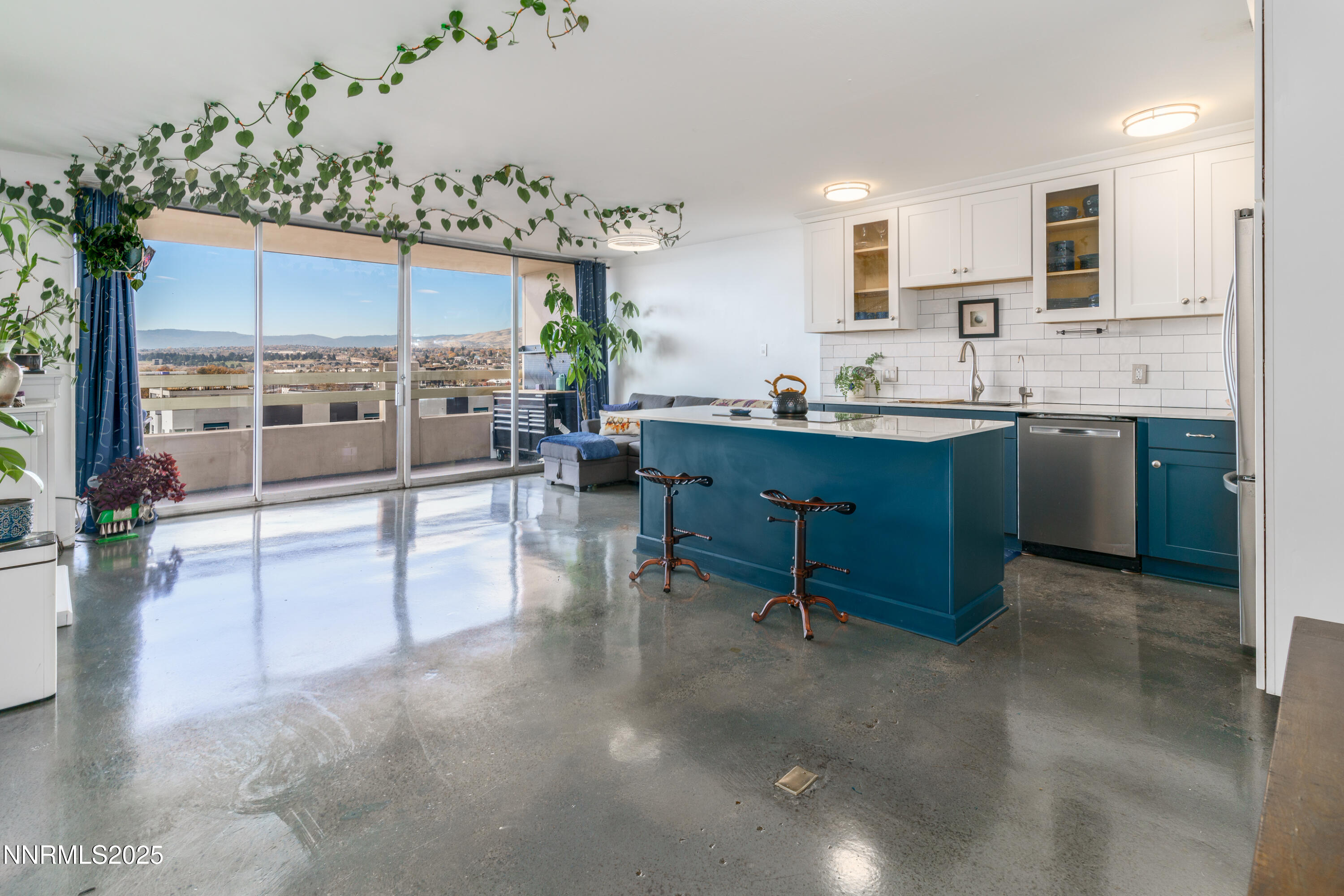 100 North Arlington Avenue, Unit 7I Reno, NV 89501 - Photo 1 of 25 a kitchen with granite countertop a sink stove and cabinets