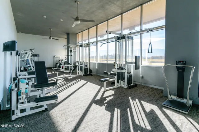 a living room with furniture a flat screen tv and a large window