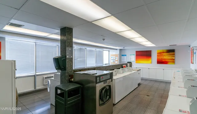a utility room with multiple dryer and washer