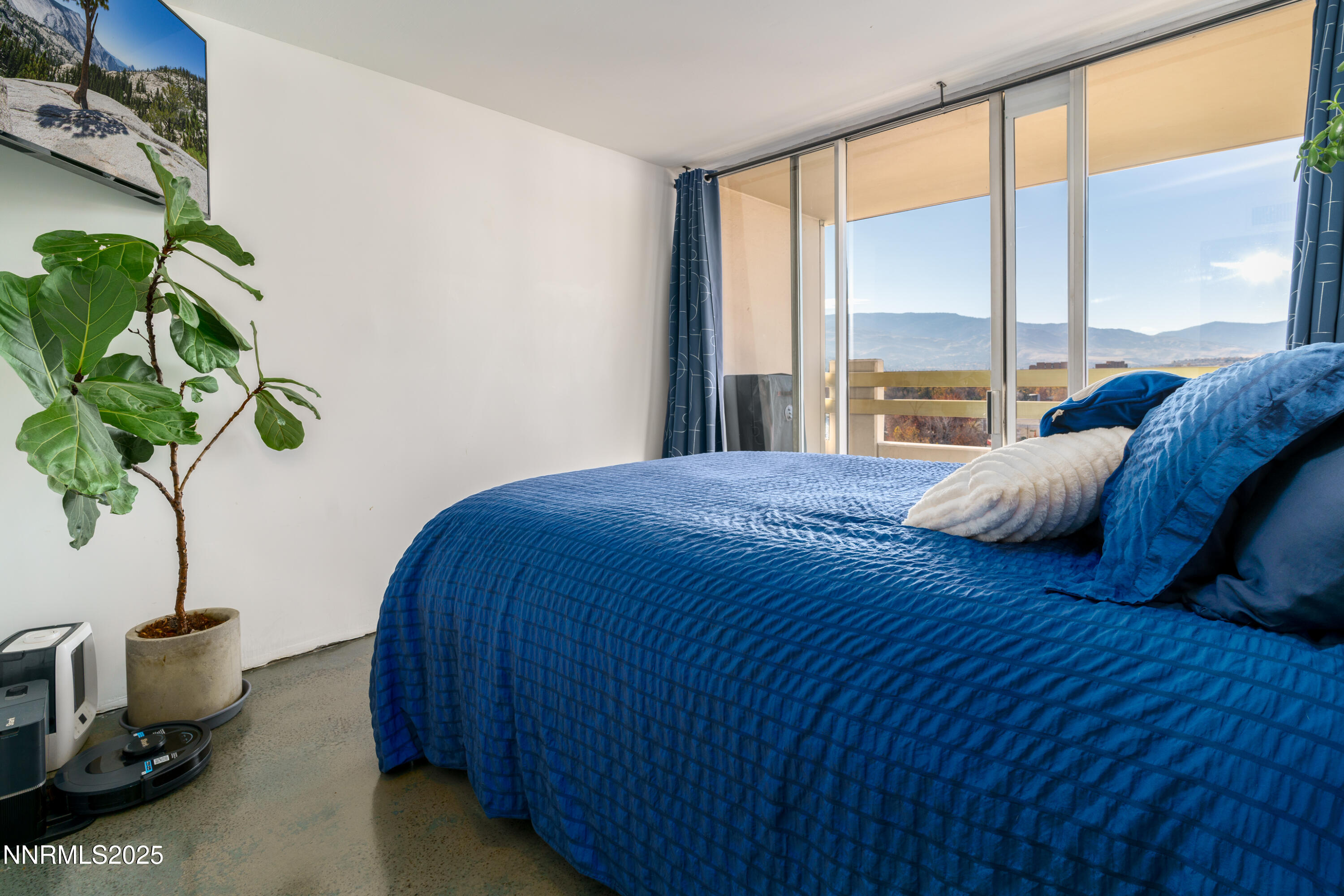 100 North Arlington Avenue, Unit 7I Reno, NV 89501 - Photo 10 of 25 a bedroom with a bed table flowerpot and window