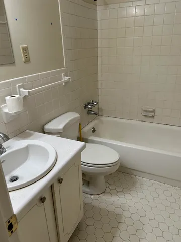 a bathroom with a sink a toilet and bathtub