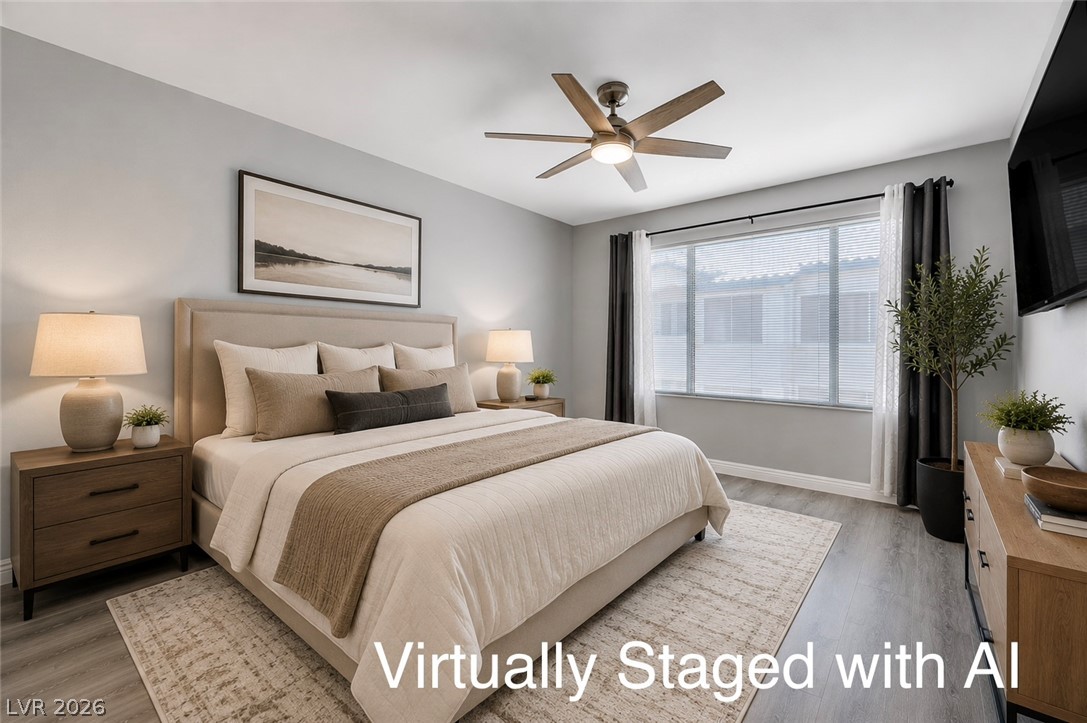 3425 East Russell Road, Unit 223 Las Vegas, NV 89120 - Photo 20 of 47 Relax in this tranquil bedroom, featuring a warm wooden ceiling fan and light-filtering window blinds.