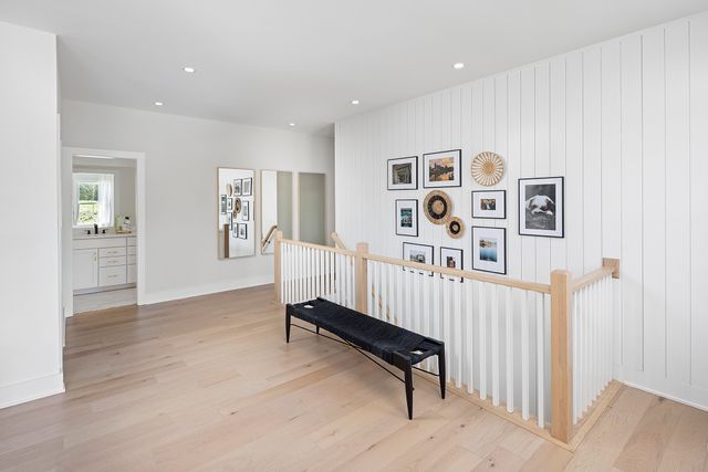 a living room with furniture and paintings on the wall