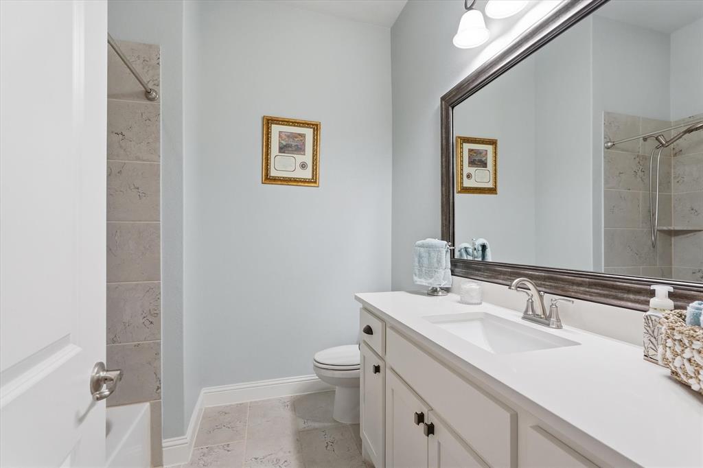 813 Mildren Lane Fate, TX 75087 - Photo 16 of 32 The hall bathroom is quite spacious and has easy access to 2 secondary bedrooms as well as the utility room.