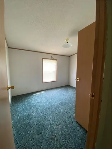 an empty room with windows and entrance
