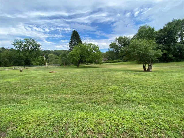 a view of outdoor space with deck and trees