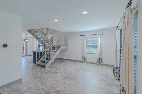 a view of an empty room with stairs