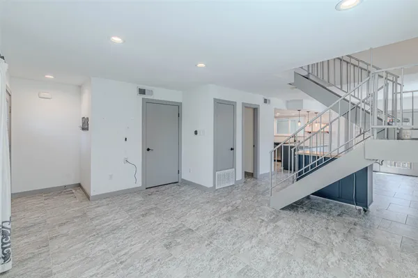 a view of an empty room with stairs