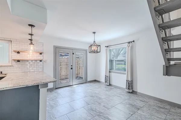 a kitchen with stainless steel appliances granite countertop a sink and refrigerator