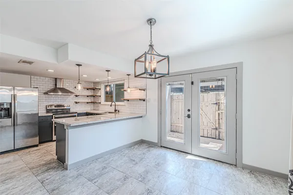 a view of a room with wooden floor and windows