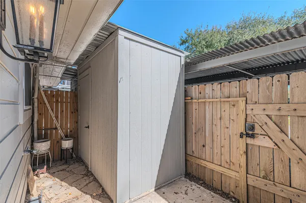 a view of a kitchen center island and stainless steel appliances