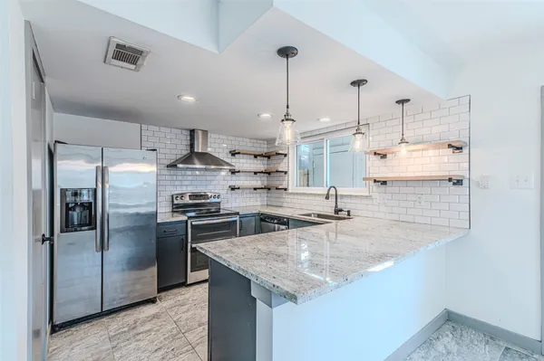 a kitchen with a stove and a refrigerator