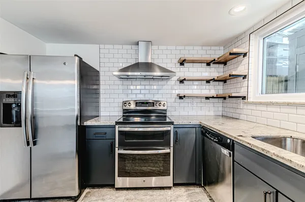 a kitchen with a sink stove and cabinets