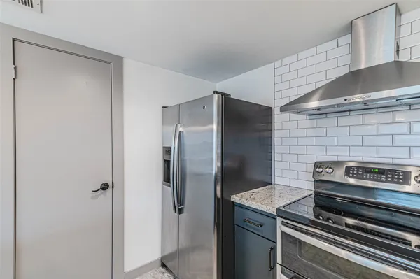 a kitchen with stainless steel appliances a sink and a refrigerator
