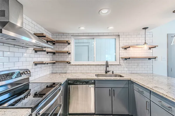 a kitchen with stainless steel appliances a refrigerator sink and cabinets