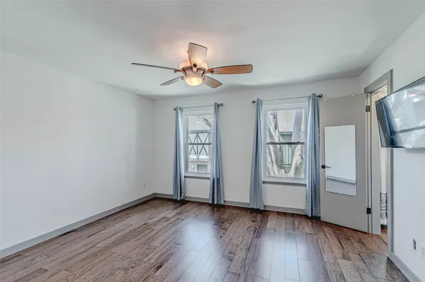 a view of hallway with wooden floor and stairs
