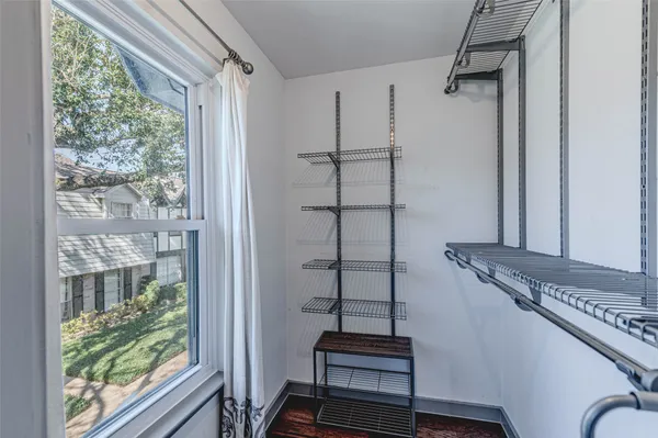 a bathroom with a granite countertop toilet sink and mirror