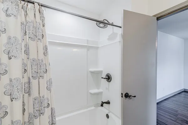 a view of empty room with wooden floor