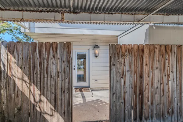 a front view of a house with a garden and trees
