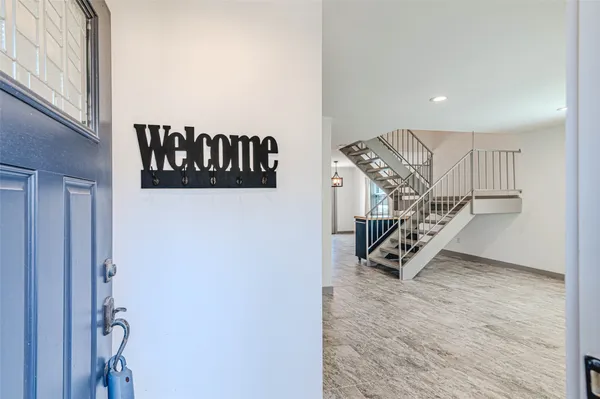 a view of a hallway with wooden floor and closet