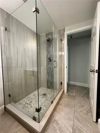 a bathroom with a shower and a sink