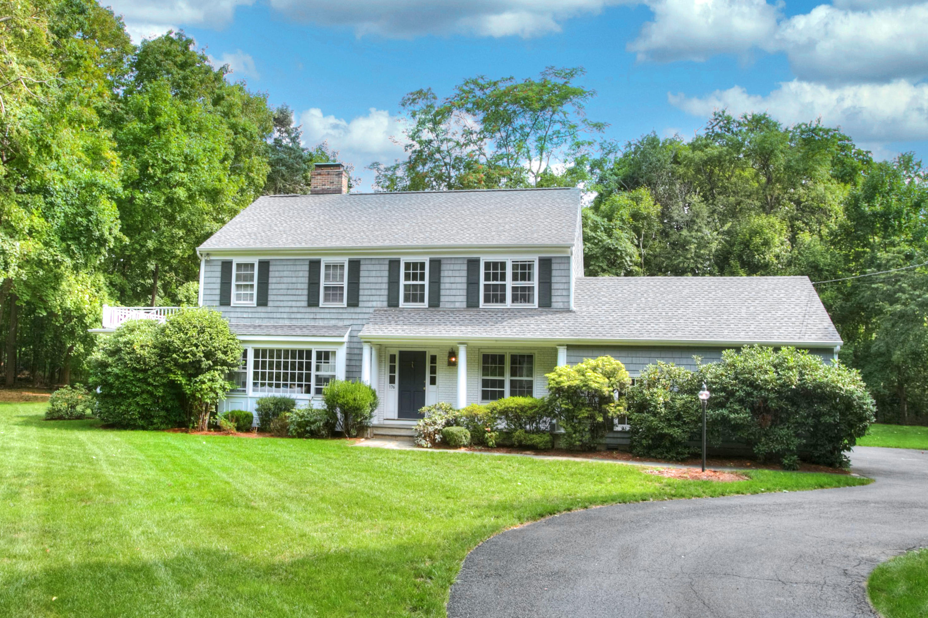 176 White Oak Shade Road New Canaan, CT 06840 - Photo 1 of 33 a front view of a house with a yard and potted plants