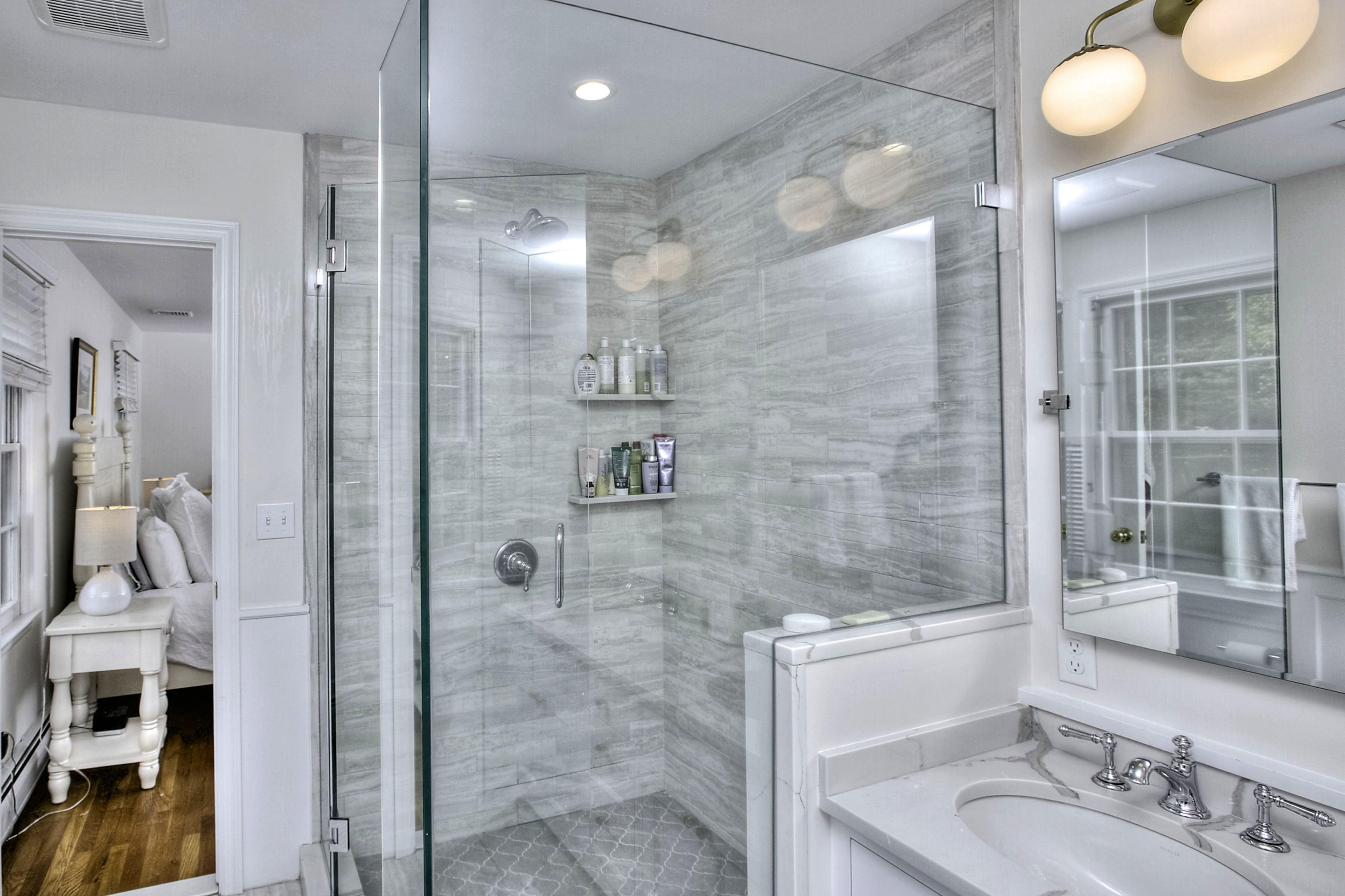 176 White Oak Shade Road New Canaan, CT 06840 - Photo 19 of 33 a bathroom with a shower sink and mirror
