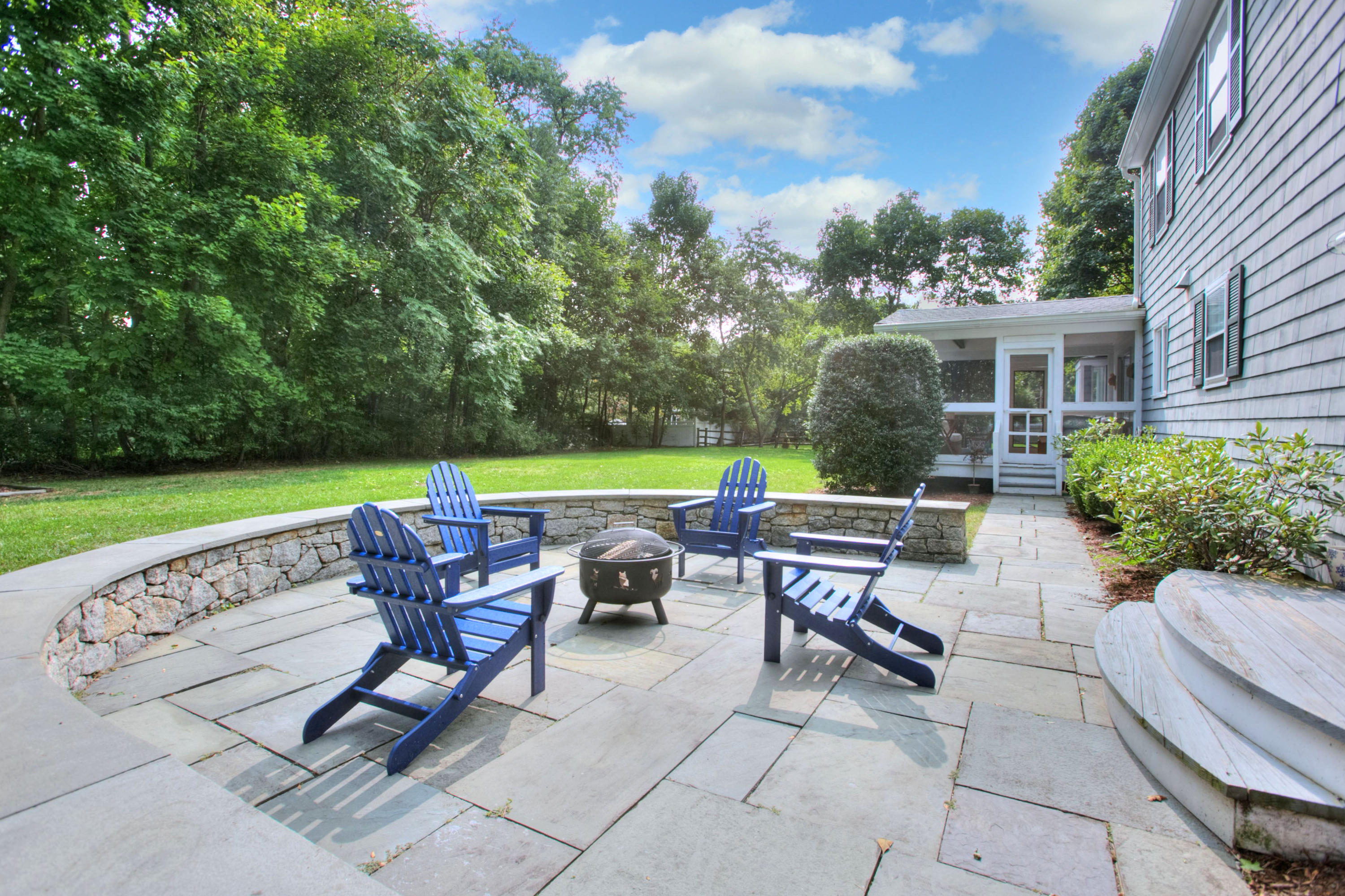 176 White Oak Shade Road New Canaan, CT 06840 - Photo 29 of 33 a view of a patio with table and chairs potted plants and a palm tree