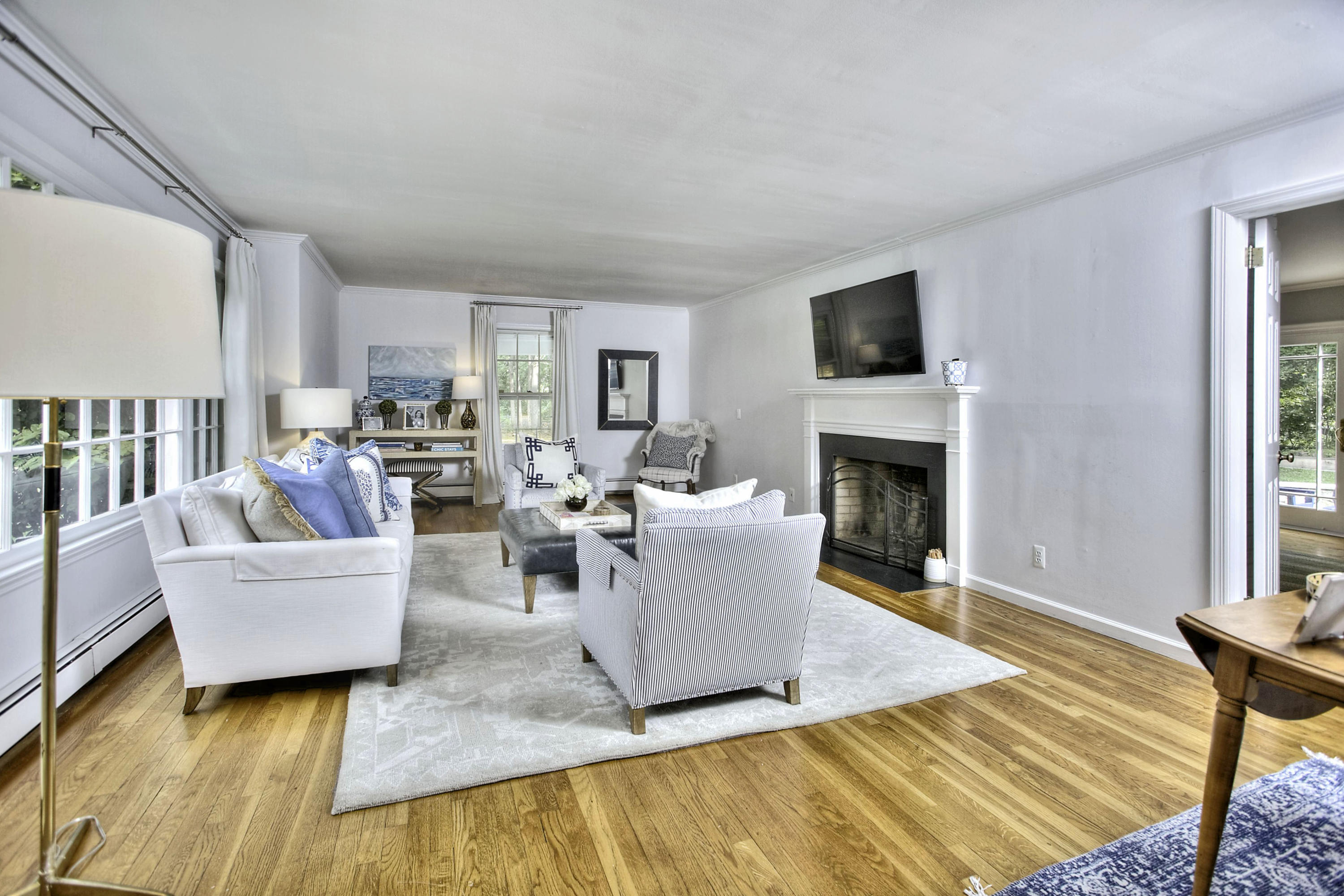 176 White Oak Shade Road New Canaan, CT 06840 - Photo 9 of 33 a living room with furniture a flat screen tv and a fireplace